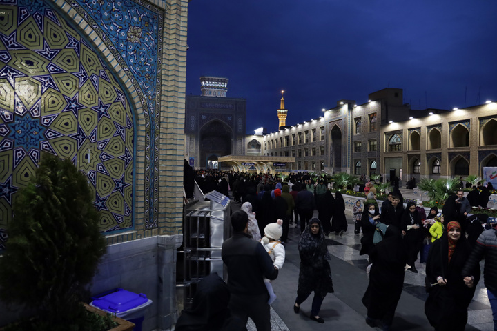Imam Mahdi’s green flag next to Imam Reza shrine dome
