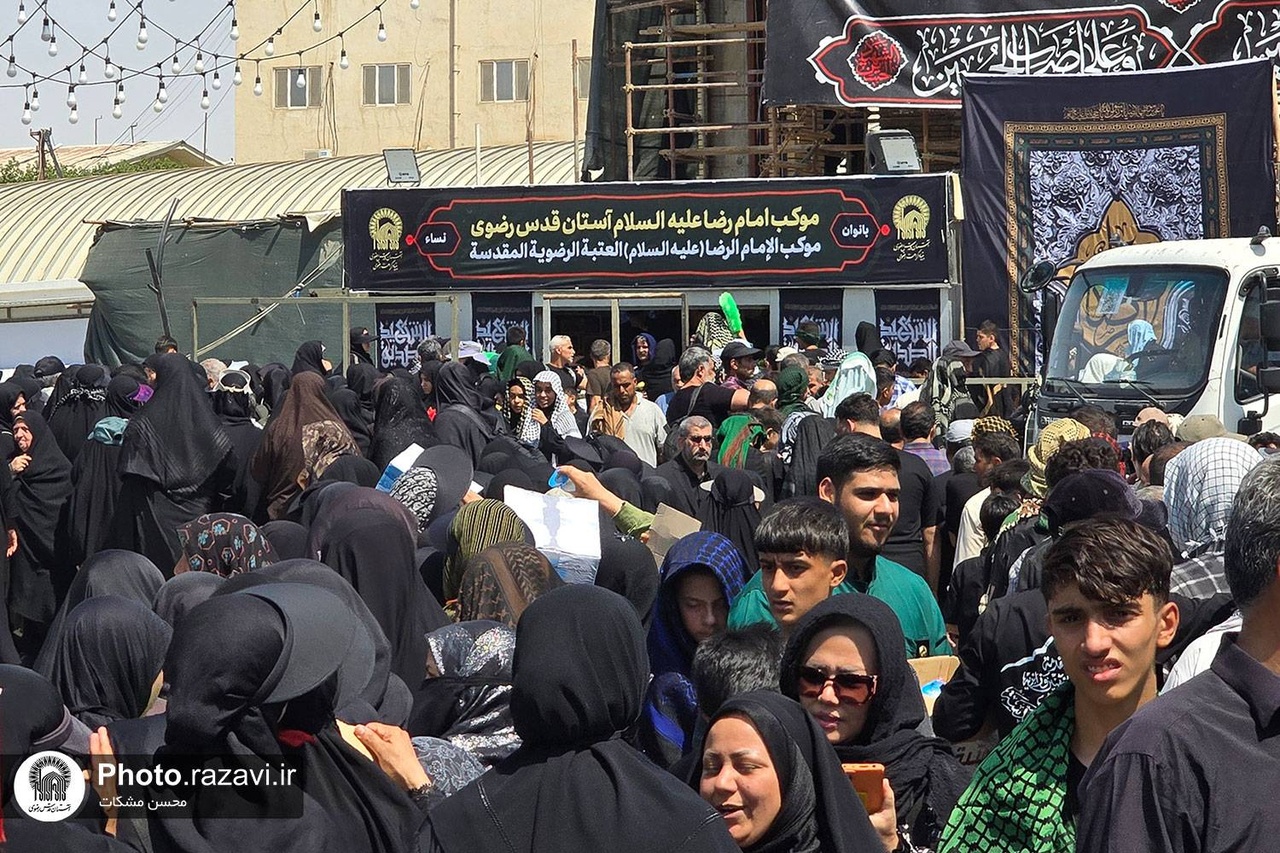 Imam Reza Shrine servants serve Arbaeen pilgrims in Najaf under Imam Reza’s banner