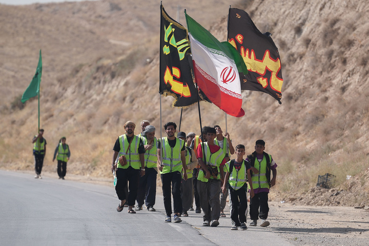 Imam Javad Mukib serves pilgrims walking to Imam Reza Shrine