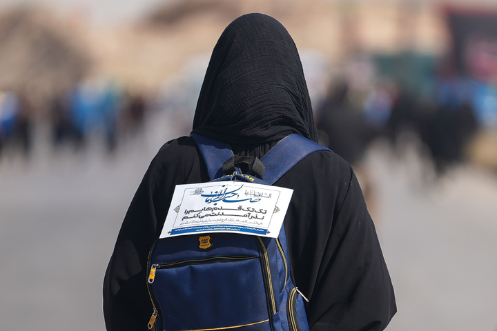 Imam Javad Mukib serves pilgrims walking to Imam Reza Shrine