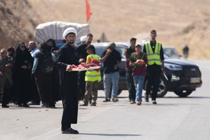 Imam Javad Mukib serves pilgrims walking to Imam Reza Shrine