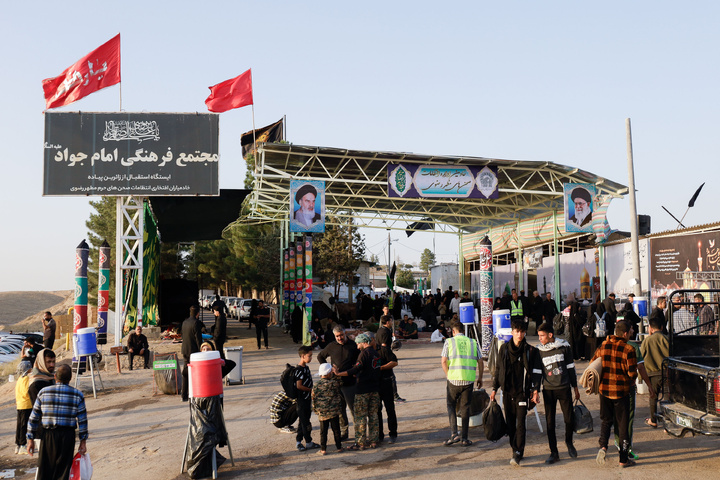 Imam Javad Mukib serves pilgrims walking to Imam Reza Shrine