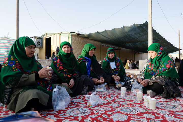 Imam Javad Mukib serves pilgrims walking to Imam Reza Shrine