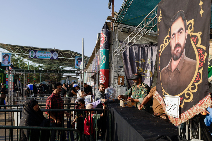 Imam Javad Mukib serves pilgrims walking to Imam Reza Shrine