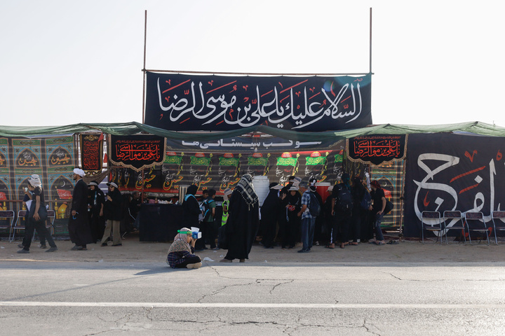 Imam Javad Mukib serves pilgrims walking to Imam Reza Shrine