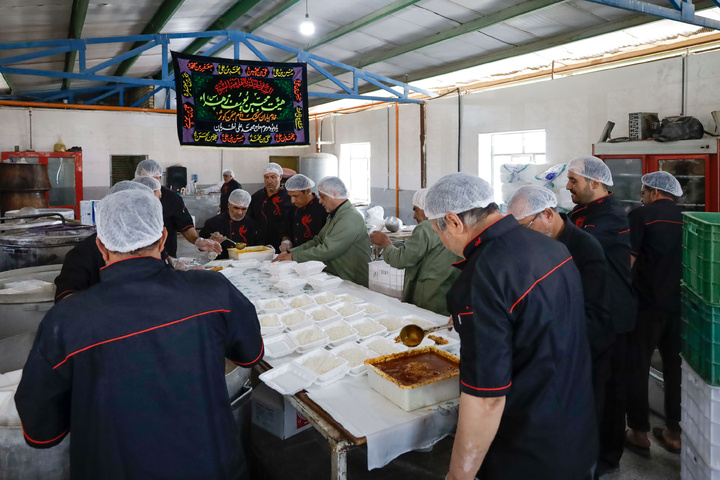 Imam Javad Mukib serves pilgrims walking to Imam Reza Shrine