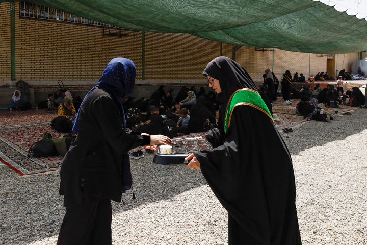 Imam Javad Mukib serves pilgrims walking to Imam Reza Shrine