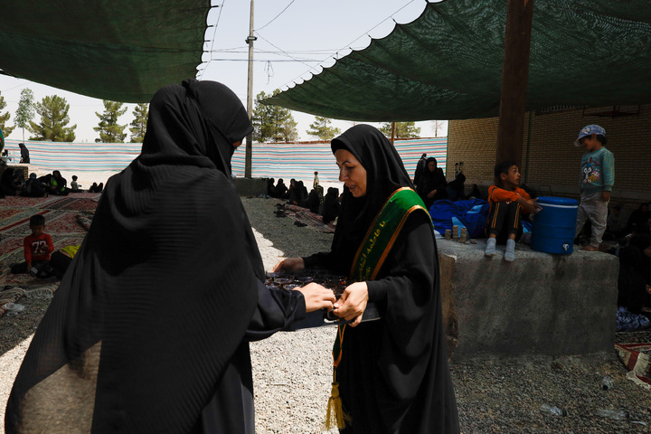 Imam Javad Mukib serves pilgrims walking to Imam Reza Shrine