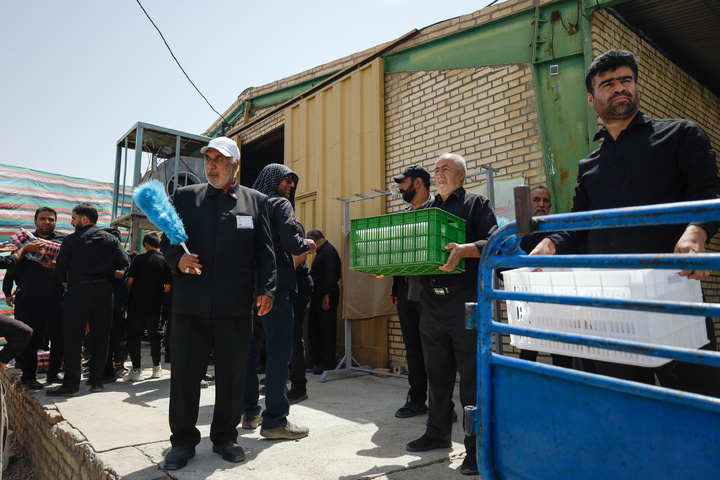 Imam Javad Mukib serves pilgrims walking to Imam Reza Shrine