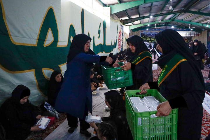 Imam Javad Mukib serves pilgrims walking to Imam Reza Shrine